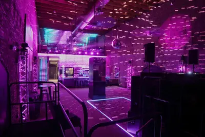 Downstairs dance floor in magenta club lighting