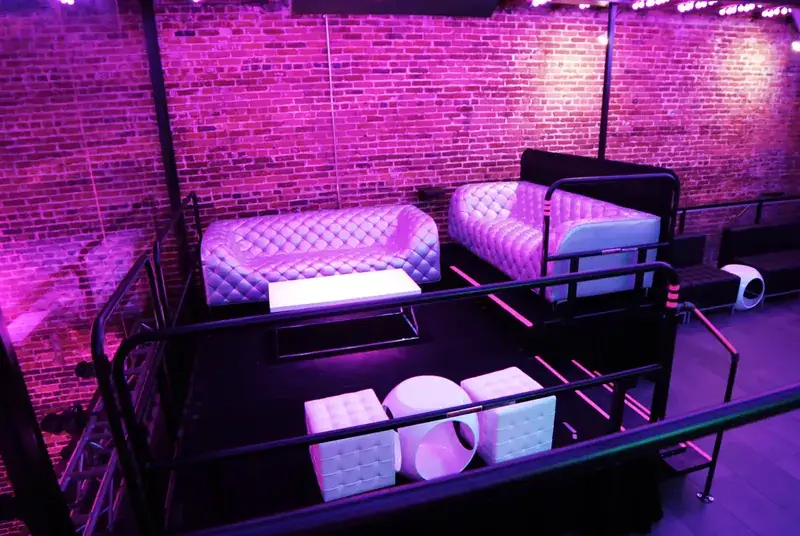 Late Nite upstairs VIP booths under magenta club lighting