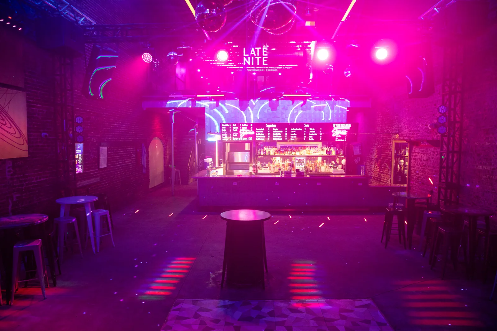 The main bar at Late Nite under magenta light